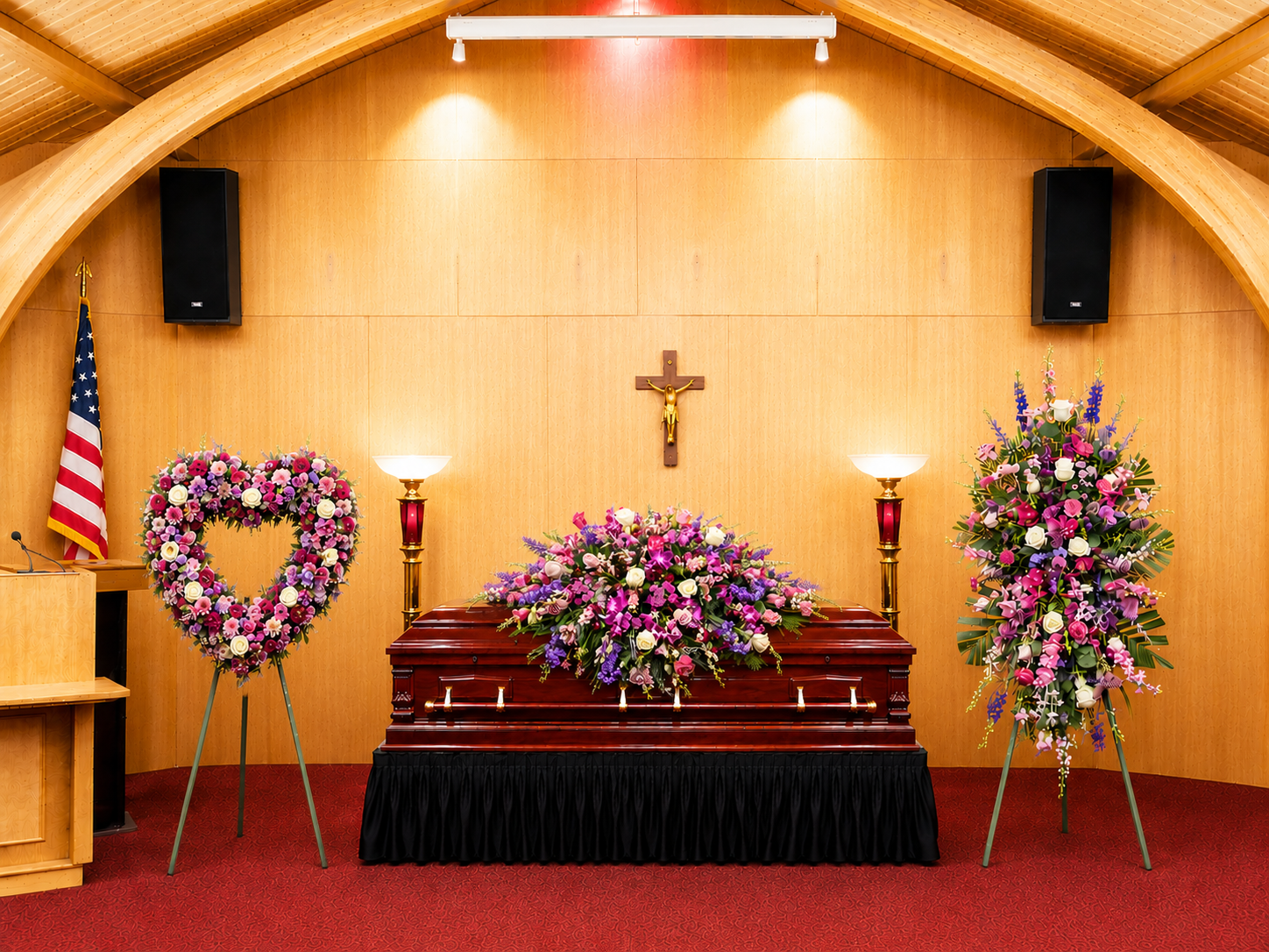 Casket with floral arrangements in a funeral home setting