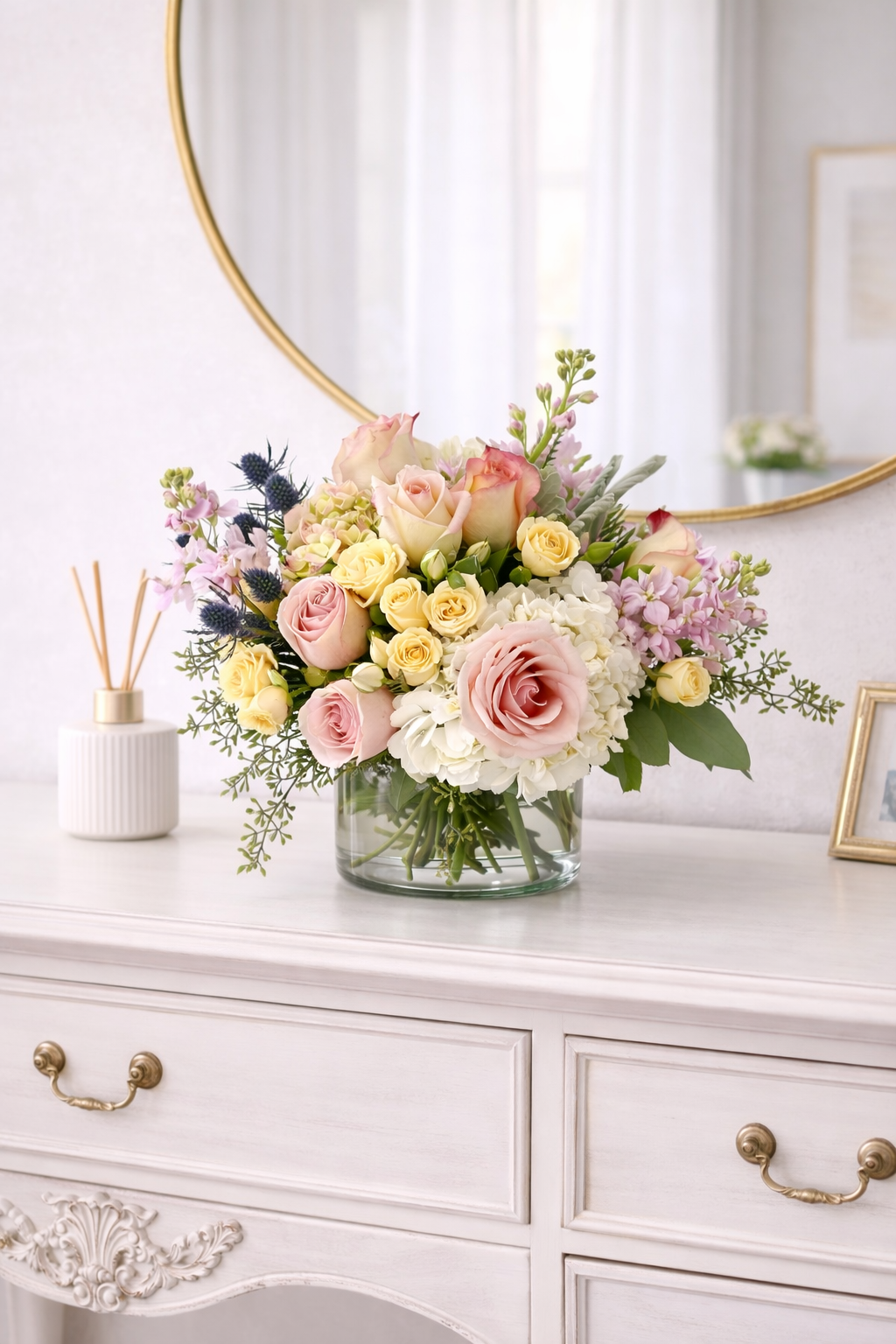 Bouquet of flowers on a white dresser with a mirror in the background