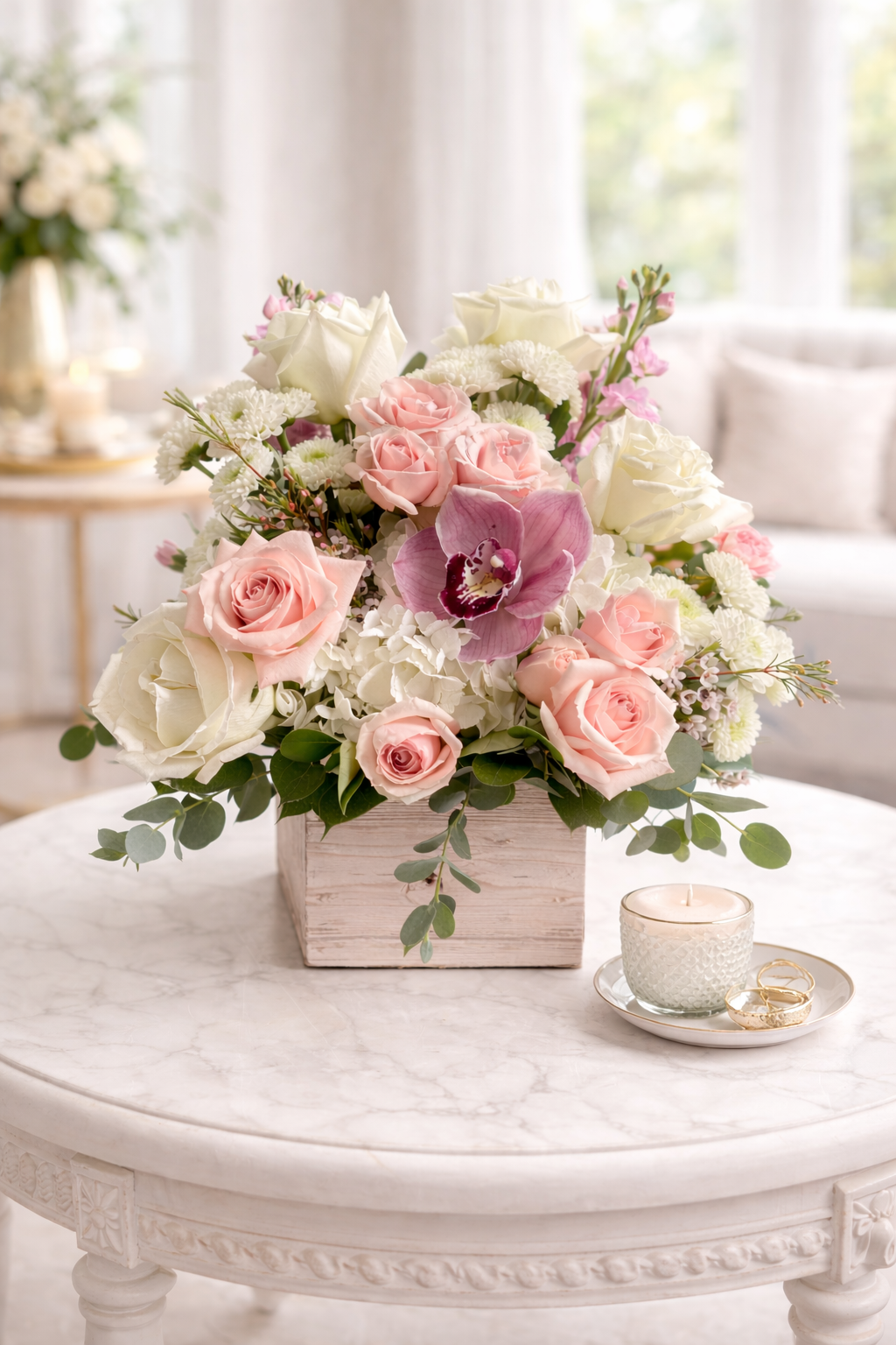 Floral arrangement with pink and white flowers in a wooden box on a marble table.