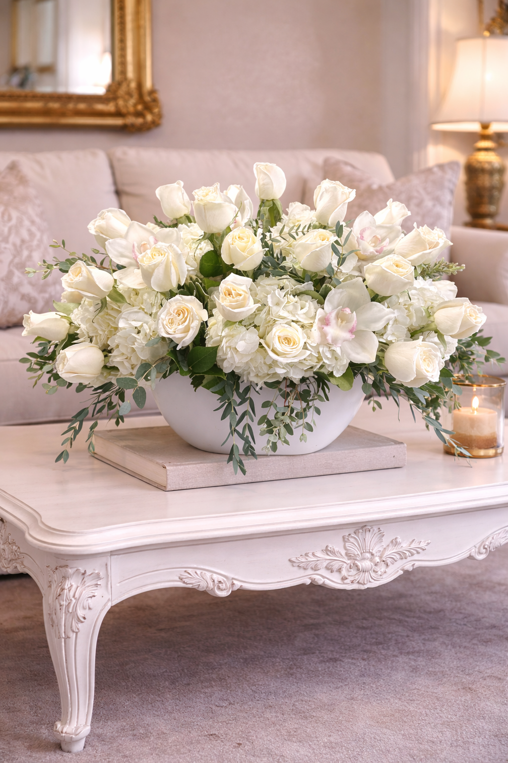 White floral arrangement on a decorative coffee table in a living room.